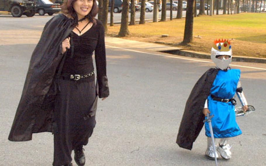 Carm Delacruz and Jared Hazlett, 4, arrive at the 2nd ID Museum Halloween Party on Friday at Camp Red Cloud, South Korea.
