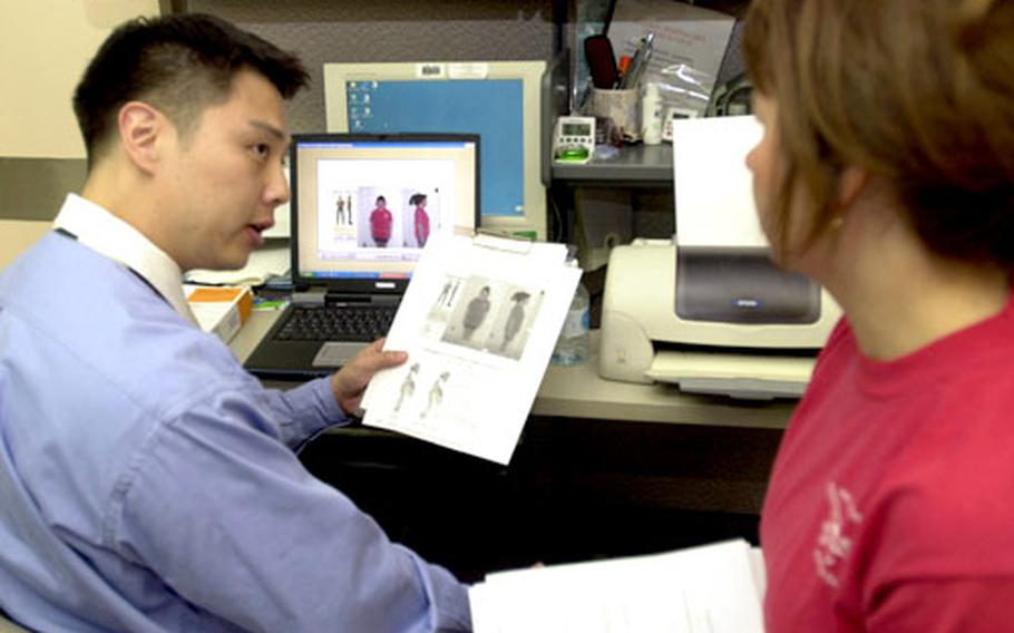 Dr. Phillip Yoo, a chiropractor, uses a computer modeling program to analyze participants’ posture at the Total Fitness Clinic last week on Yongsan Garrison.