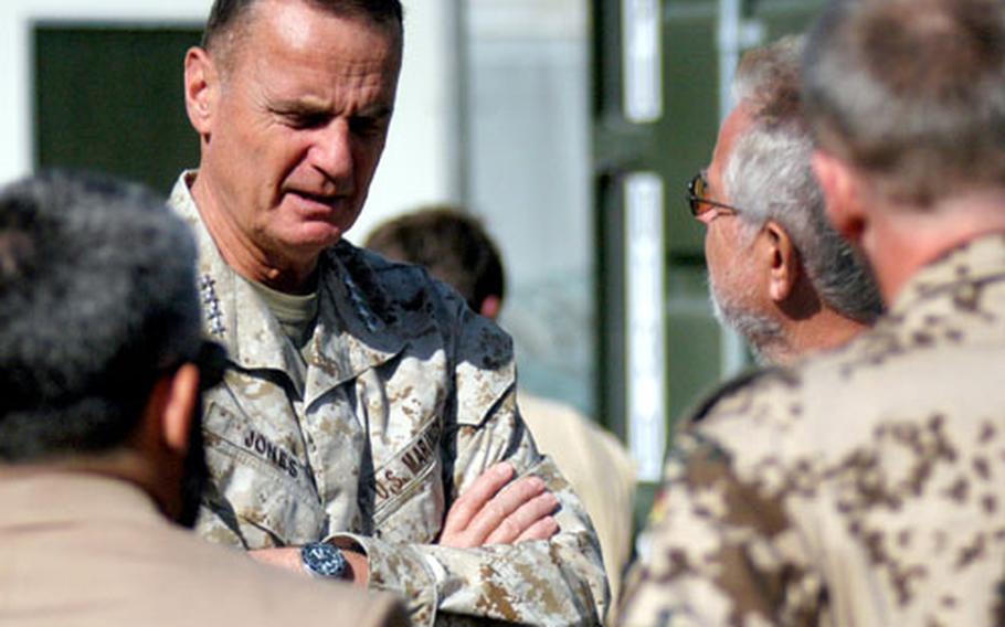 U.S. Marine Gen. James L. Jones, supreme allied commander of NATO’S military arm, talks with German officials Sunday during a visit to a provincial reconstruction camp in Kunduz, Afghanistan.
