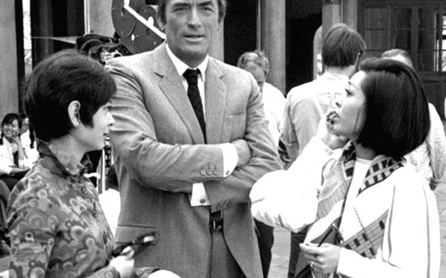 Gregory Peck with actresses Zienia Morton, left, and Francisca Tu on the set of ''The Chairman.''
