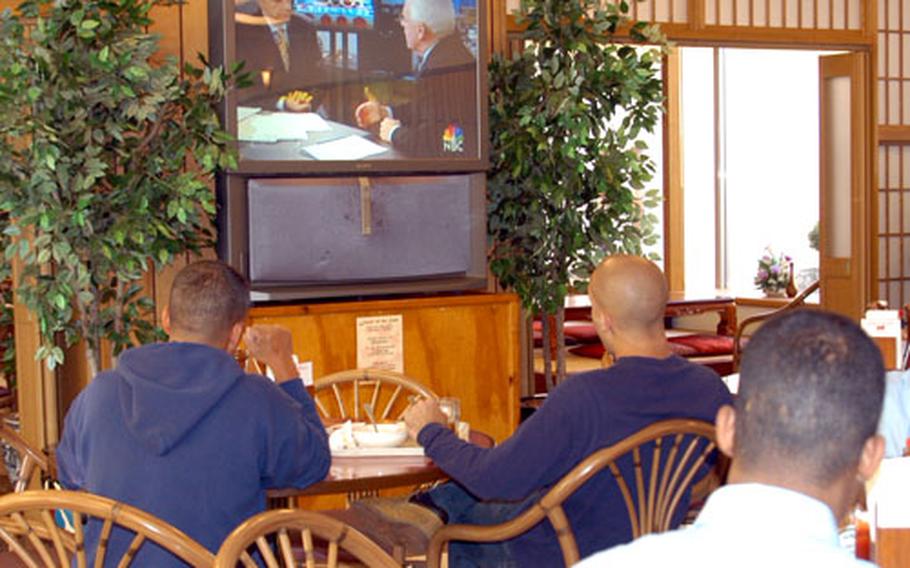 Sailors at Yokosuka Naval Base&#39;s main galley watch election returns during lunch Wednesday.