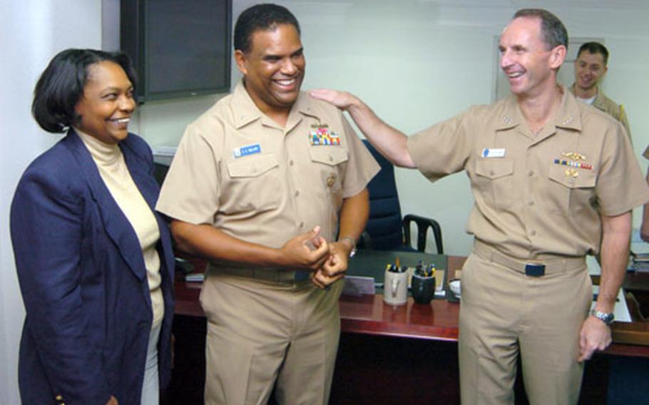 Vice Adm. Jonathan Greenert, right, congratulates newly-promoted Rear Adm. Victor Guillory, center, and his wife, Marquita, after a frocking ceremony onboard the USS Blue Ridge on Thursday. Guillory commands Amphibious Force U.S. Seventh Fleet.