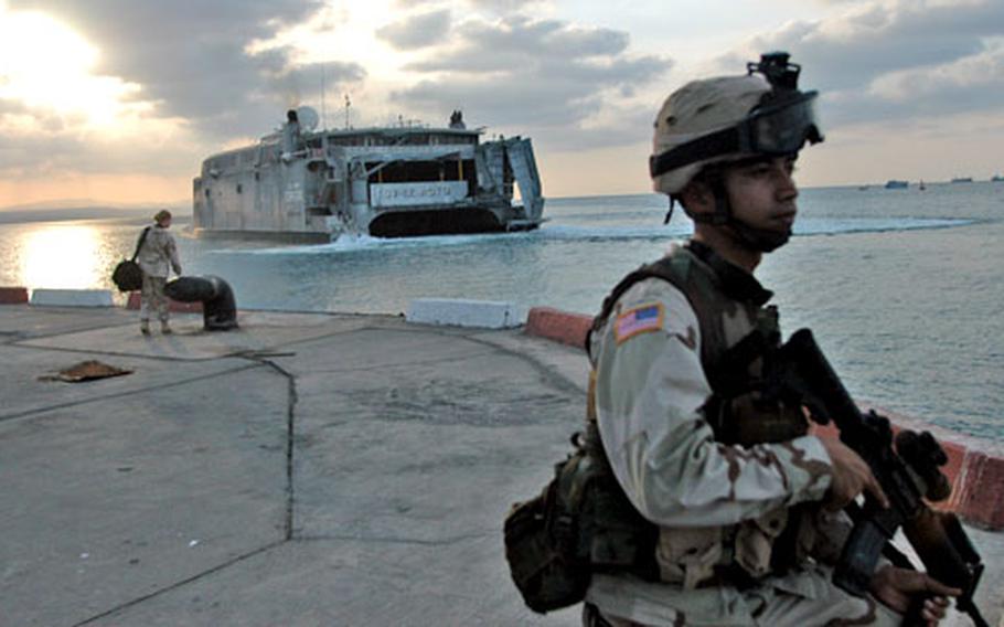 Sgt. Michael Taman of Mangilao, Guam, and the Guam Army National Guard keeps watch as an Army ship pulls into port Wednesday.