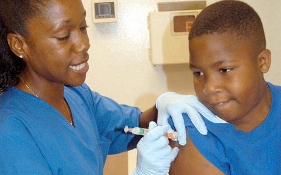Immunizations Nurse Maruja Johnson, left, vaccinates 7-year-old Sam H. Scott against the flu recently at U.S. Naval Hospital Okinawa. Sam, who has asthma, was one of the first children to receive the flu shot this year.