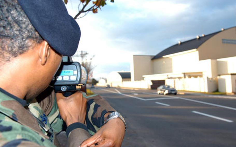 Staff Sgt. Lawrence McKnight, of the 35th Security Forces Squadron at Misawa Air Base, Japan, demonstrates a hand-held laser gun that can instantly track vehicle speed and distance traveled. The squadron recently upgraded its speed-tracking equipment in hopes of reducing speeding — the No.1 cause of accidents and traffic complaints at Misawa.