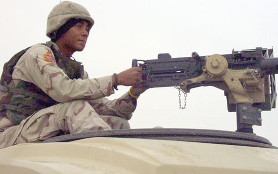 Spc. David Wallace, 19, of Eaton, Ohio, sits in the gunner&#39;s mount atop an armored Humvee from the 518th Gun Truck Company, a provisional unit made up of National Guardsmen from Ohio, North and South Carolina, Virginia and Louisiana.