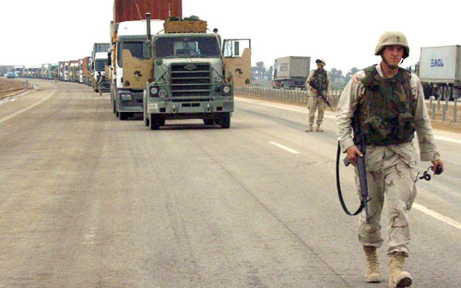 Staff Sgt. Dan Miller, commander of the Iraqi Express spare-parts convoy, strides forward toward the lead gun truck as the convoy takes a break.