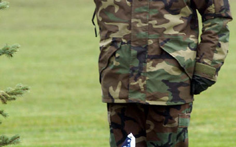 Spc. Anthony Cabrera, of Headquarters and Headquarters Company, 141st Signal Battalion, salutes after placing a flag in front of a marker representing World War II during the Veterans Day ceremony at Wiesbaden Army Airfield, Germany, on Wednesday. A flag was placed for all conflicts fought by the U.S. military since World War I at the ceremony.