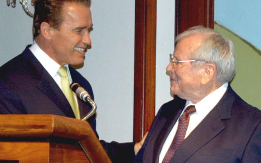 California Gov. Arnold Schwarzenegger, left, thanks the U.S. Ambassador to Japan, Howard Baker, for his introduction to the guests of Marine Security Guard Detachment Tokyo&#39;s Marine Corps Ball.