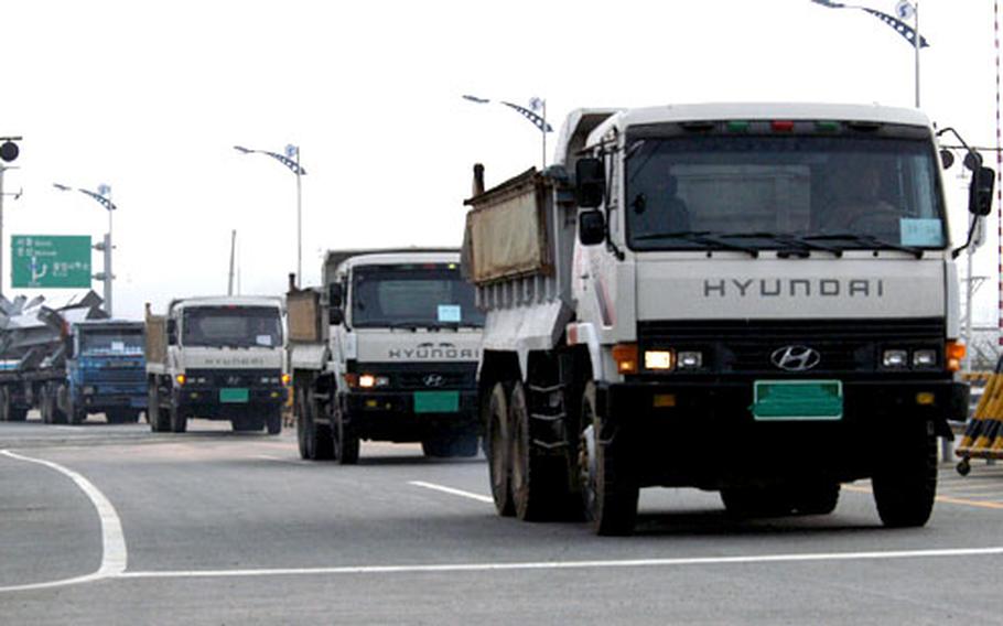 Construction equipment, fuel and workers pass through a gate from South Korea into North Korea on Tuesday along the Western Transportation Corridor. The convoy is headed for the Kaesong Industrial Park project, an effort by both Koreas to bring more jobs and investment into North Korea. Officials hope to open 15 factories there by next year.