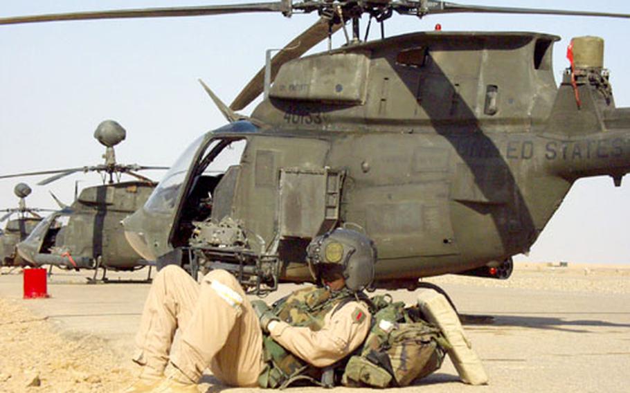 Capt. Dale Bond, 24, a Kiowa Warrior pilot with the 1st Armored Division’s 1st Squadron, 1st Cavalry Regiment’s Troop D, catches a few winks next to some of the birds.