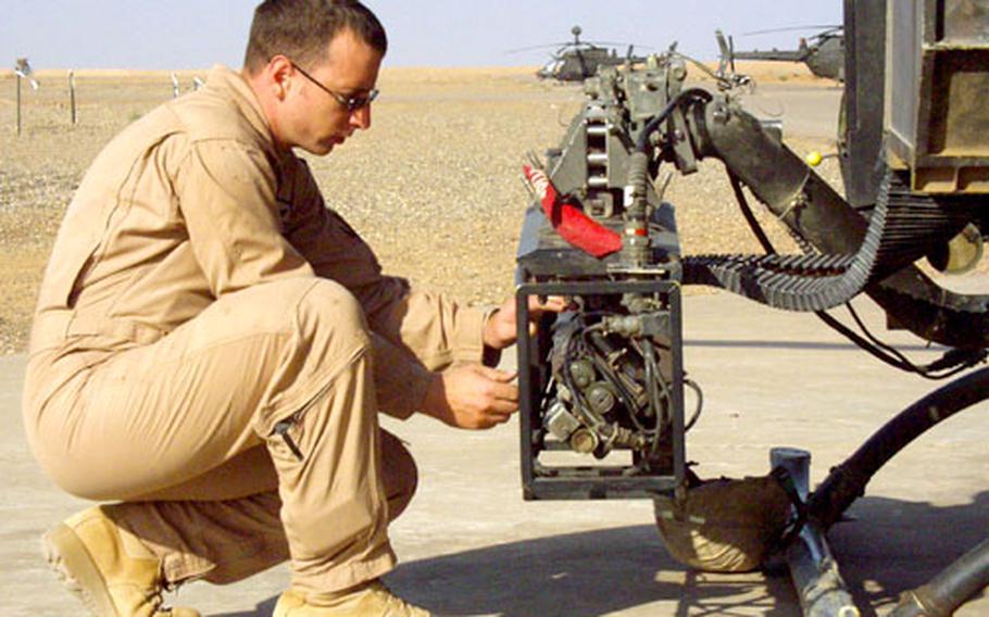 Chief Warrant Officer 2 W. Lance Johnson, 29, an OH-58 Kiowa Warrior pilot, inspects the gun mount on his helicopter. Johnson said the move from Europe will be a little disappointing. “But I’m going to Hawaii afterward, so that made the pain a little more bearable,” he said.