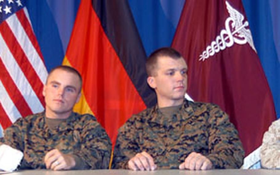 From left to right, Army Spc. Kris Clinkscales and Marine Lance Cpls. Travis Schafer, Ryan Chapman and Jeffery Owens, all wounded during fighting in Fallujah, Iraq, talk to the media at Landstuhl Regional Medical Center on Monday.