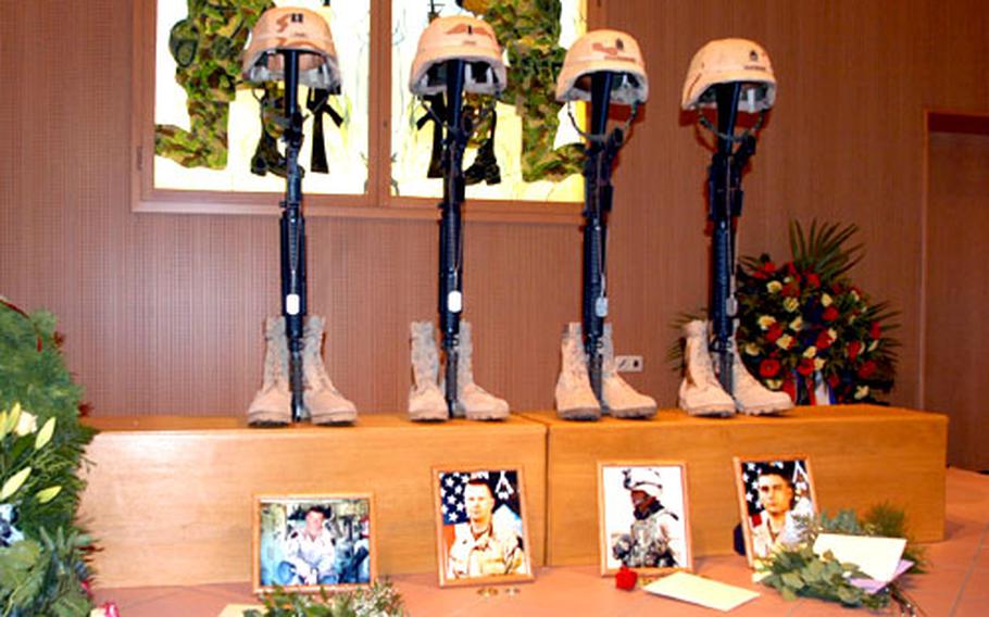 The helmets, rifles, dog tags and boots of Capt. Sean Sims, 1st Lt. Edward Iwan, Command Sgt. Maj. Steven Faulkenburg and Sgt. James Matteson stand Wednesday at the front of the Vilseck Chapel during a memorial service for the four 2nd Battalion, 2nd Infantry Regiment soldiers killed last week in fighting in Fallujah, Iraq.