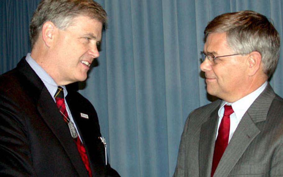 USO President Edward Powell Jr., left, talks with Charles Abell, principal Under Secretary of Defense for Personnel and Readiness, after Friday&#39;s Pentagon rollout of the new "America Supports You" program.