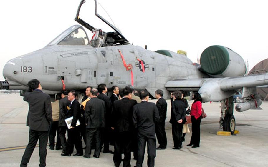 South Korean journalists and professors get a close look at an A-10 Thunderbolt II attack plane Friday at Osan Air Base, South Korea. The plane is with the 25th Fighter Squadron, part of Osan’s 51st Fighter Wing. The group visited the base as part of a seminar on South Korean security sponsored by the U.S. Embassy in Seoul.