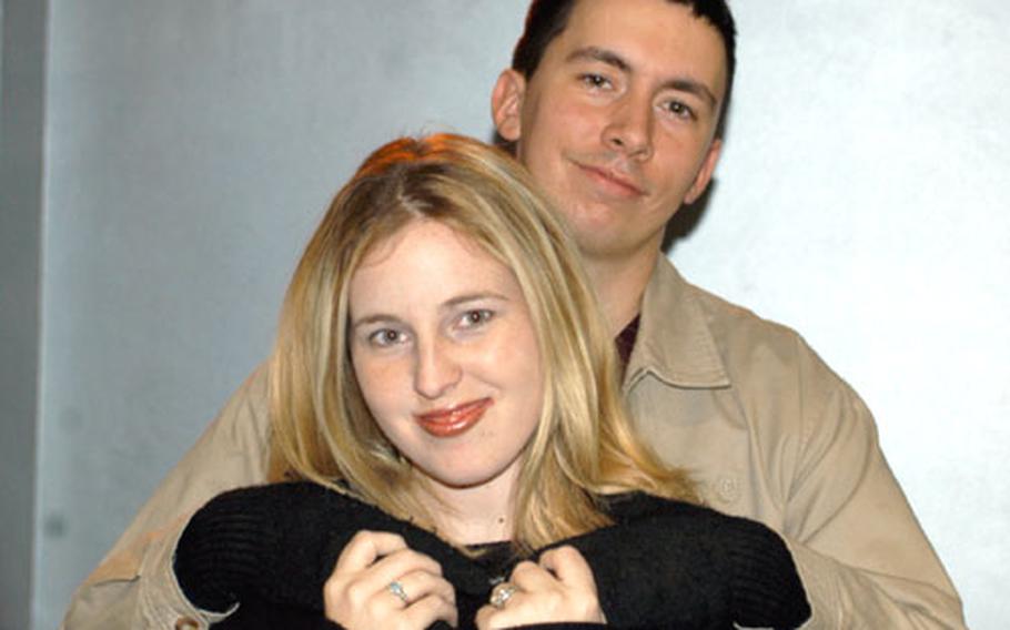 Chelsea Nicole Pedro is hugged by her husband, Pfc. Brendon Pedro, in Wiesbaden, Germany. Pedro recorded an independent CD while her husband was in Iraq.