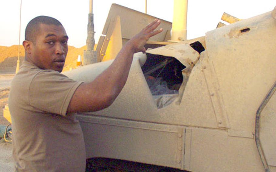 Sgt. Orville Whitlock, 30, of Lynchburg, Va., explains how a rocket-propelled grenade hit his Company B, 9th Engineer Battalion Humvee during a patrol May 5. Whitlock and four other soldiers received shrapnel wounds — which he said “feels like someone sliced open your back and poured in hot chicken grease” — but all survived.