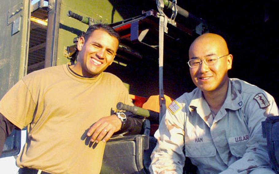 Sgt. Anthony Troche, 28, left, and Pfc. Jihoon Ham, 24, survived a roadside bomb attack in September that flattened the rear tires of their Army ambulance and sent shrapnel flying through the empty patient compartment in the rear. Both are members of the 557th Medical Company (Ground Ambulance), based in Wiesbaden, Germany, and operating from Camp Speicher, Iraq.