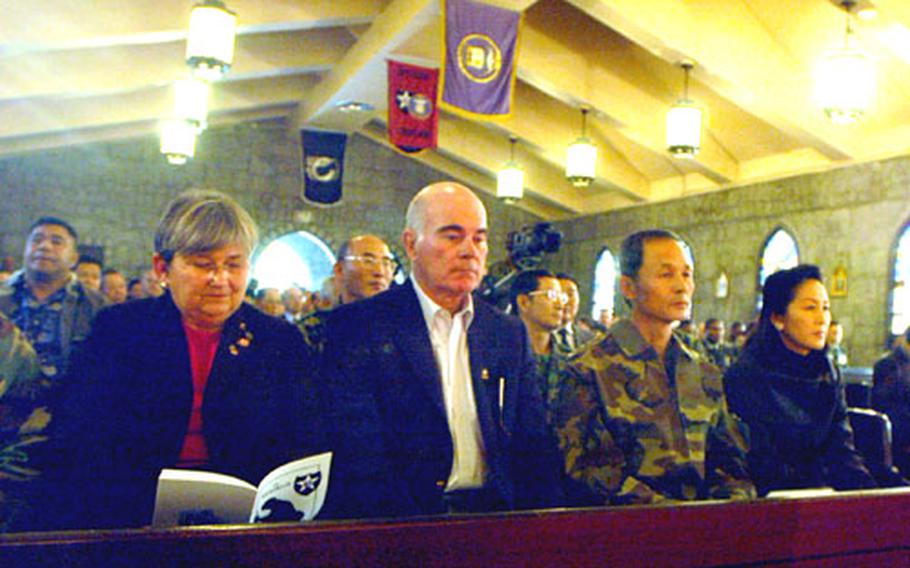 Secretary of the Army Francis J. Harvey, center, listens at Wednesday&#39;s Camp Cloud memorial service in which Strike Force soldiers who were killed in Iraq were honored.