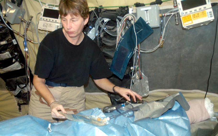 Capt. Debra Nichols, a nurse at the Air Force Theater Hospital at Balad Air Base, Iraq, prepares a post-surgery patient for movement. The hospital treated hundreds of patients during a surge of wounded from the recent fighting in Fallujah.
