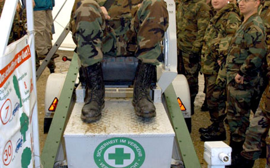 Pvt. Cameron Barrows, Headquarters and Headquarters Company, 1st Battalion, 4th Infantry Regiment, laughs after coming to a dead stop in the seatbelt convincer in Hohenfels, Germany. The machine is designed to show people how valuable the seatbelt is in keeping passengers in their seats even in low-speed collisions.
