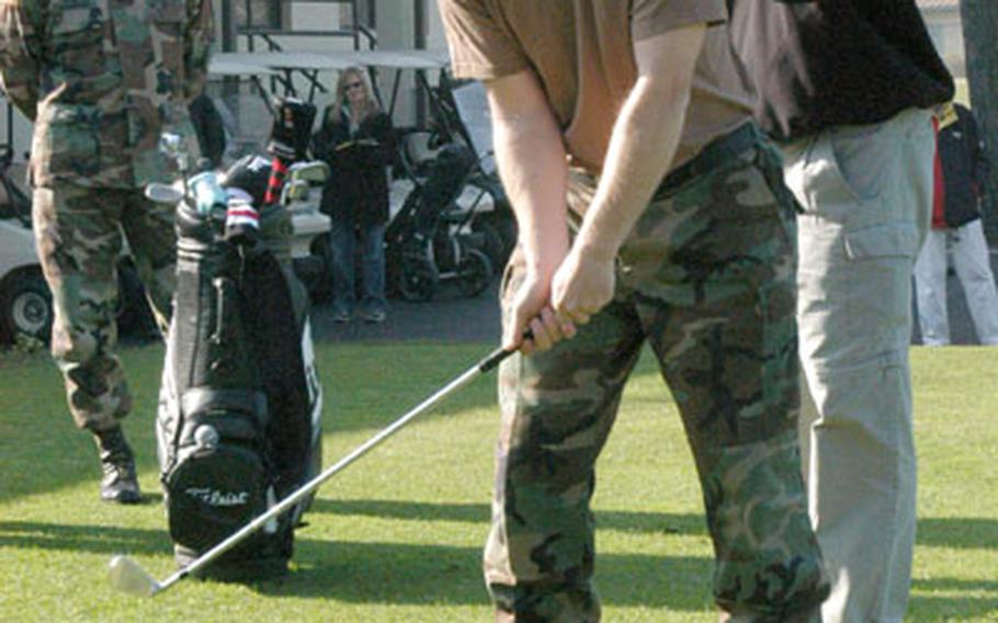 On the golf course at Camp Walker in Taegu, South Korea, Frank Lickliter II, right, a touring pro with the Professional Golfers Association, gives golfing pointers to Army Staff Sgt. Richard Young, 8th U.S. Army golf champion, during a golf clinic Monday.