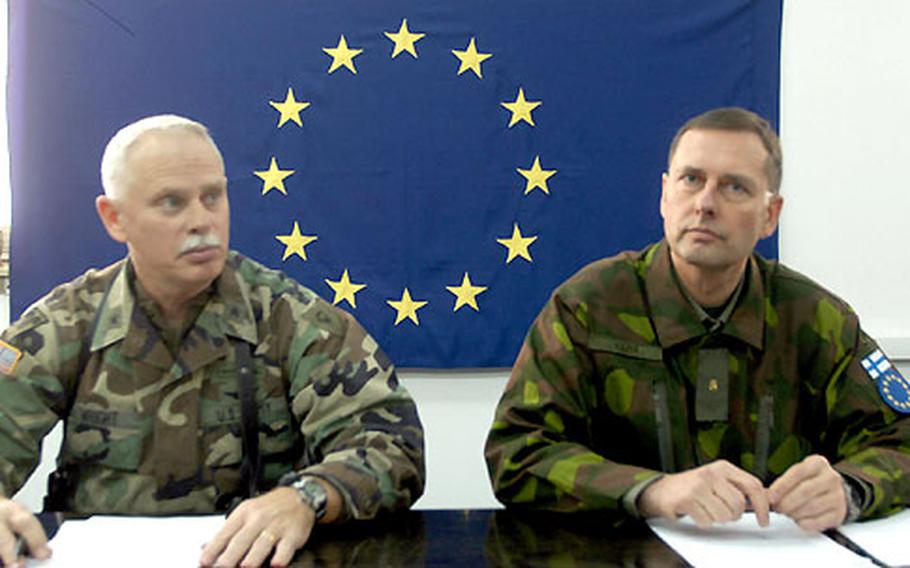 U.S. Army Brig. Gen. Timothy Wright, left, and Finnish Brig. Gen. Juha Kilpiä answer questions during a news conference Friday in Tuzla, Bosnia-Herzegovina. Wright is giving up command of Task Force Eagle as Stabilization Force ends its mission. Kilpiä will be the new commander of Multinational Task Force-North when the European Union takes over from NATO on Thursday.