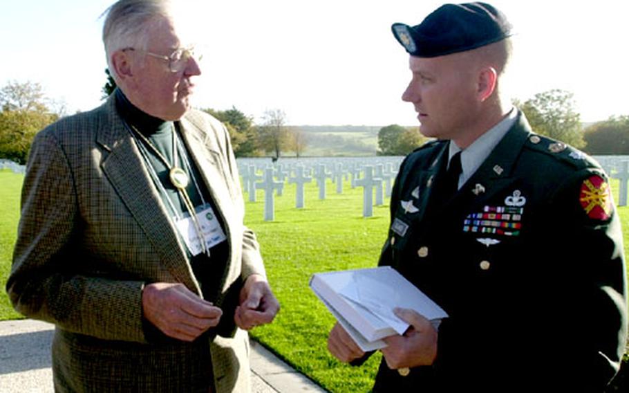 World War II veteran Jack Schwanhausser, left, president of the 104th Infantry Division Association, tells Lt. Col. Scott Glass of the 80th Area Support Group how three colonels from his division were killed at the same time. Glass met up with a tour of the 104th vets Oct. 21 at Henri-Chapelle American Cemetery in Belgium where the officers are buried.