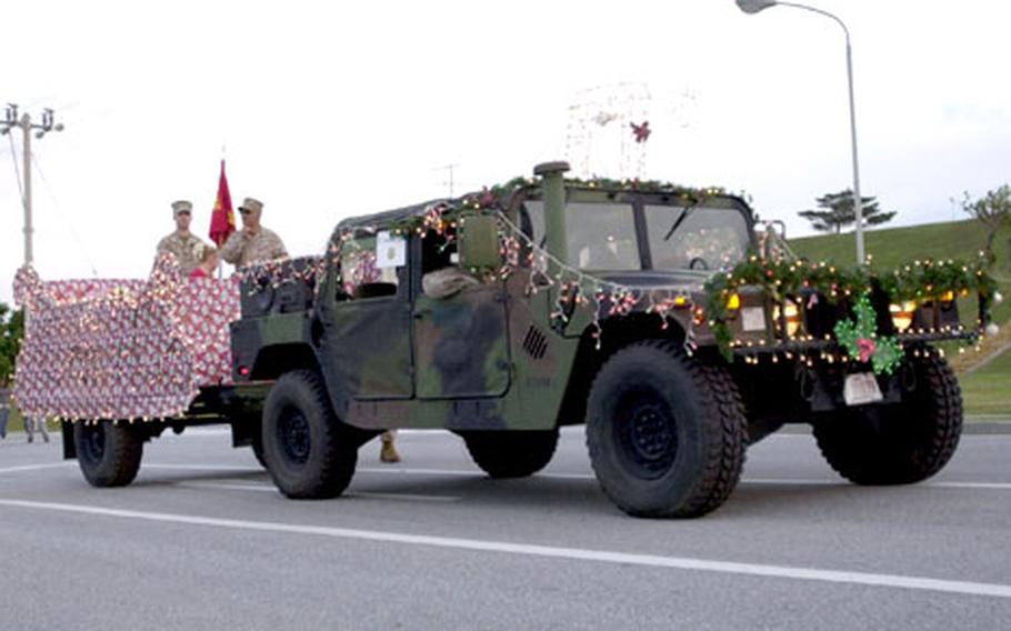 Marines got into the Christmas spirit at Camp Kinser&#39;s parade Wednesday as they decorated this Humvee and trailer for the occasion.