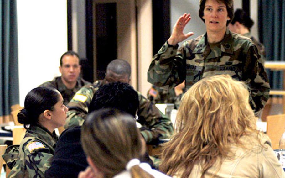 During a meeting Wednesday at Kleber Casern in Kaiserslautern, Germany, Col. Susan Sowers, commander of the 37th Transportation Command, informs family members of the 66th Transportation Company that the unit has received a two-month deployment extension in central Iraq.