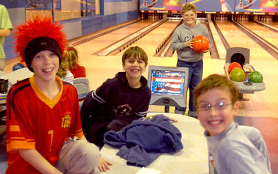 From left, David Schnibben, Jake Moffatt, Greg Meyers and Graham Young mug for the camera during a birthday party for Greg on Wednesday at the new Galaxy Bowling and Entertainment Center on Panzer Casern in Stuttgart, Germany. The center hosted 56 parties during November, its first month in business.