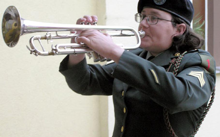 Sgt. Kerin Hoffman, 1st Infantry Division bugler, plays taps at a memorial service Thursday at the Vilseck Chapel.