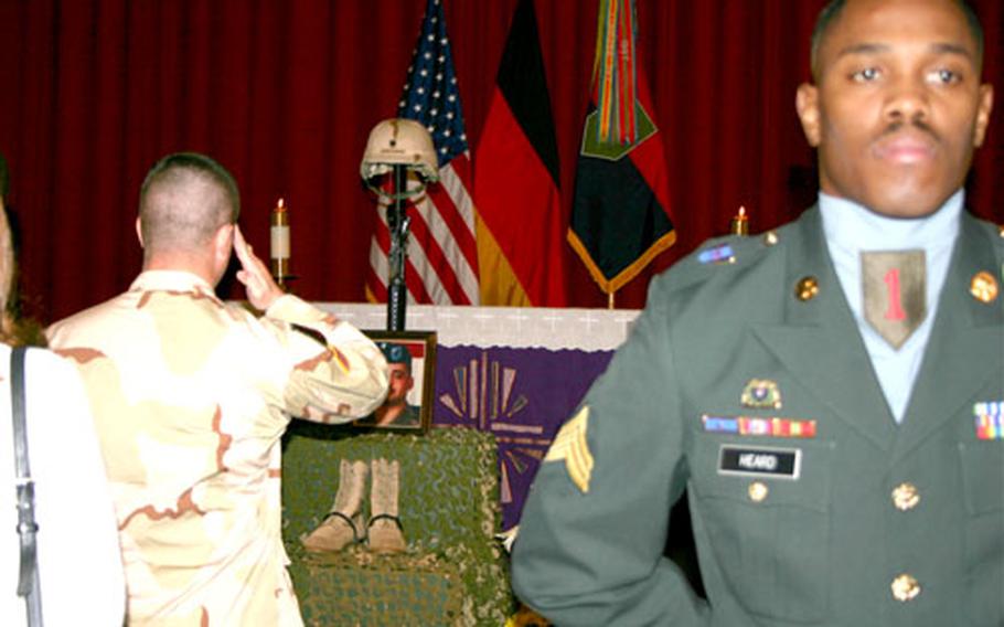 Capt. Nicholas Cook of Troop A, 1st Squadron, 4th Cavalry Regiment salutes Spc. Jeremy Christensen, his fallen comrade, following a memorial service Friday at Schweinfurt, Germany. Darren Heard, right, serves in the honor guard.