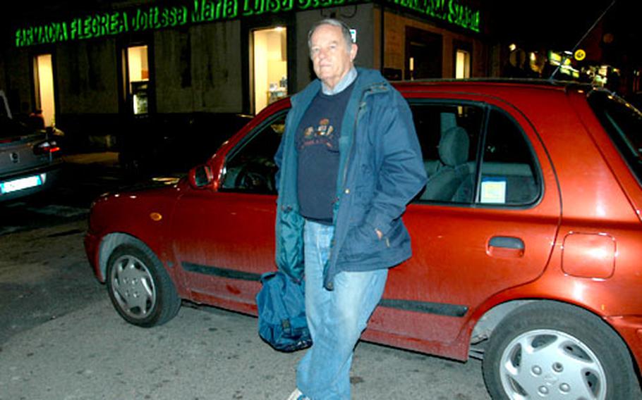 Wylie Miller leans against his new car, a maroon Nissan Micra, near the spot where his previous car was stolen in a carjacking.