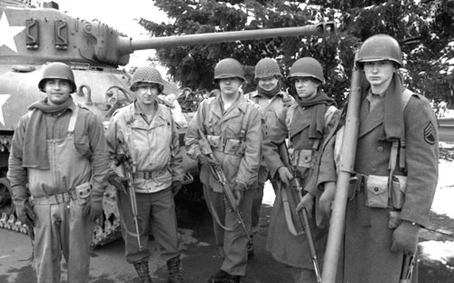 It takes a good eye to tell if this photo is from the Stars and Stripes of 2004, or 1944. With the snow, the authentic uniforms and weapons and the Sherman tank, this could be a photo from the Battle of the Bulge. In fact, it’s members of Baumholder’s Phantom Regiment in the parking lot of the base post exchange on Veterans Day. From left to right is Spec. Jonathon Parker, Command Sgt. Maj. Joseph Hall, Pfc. Edward Thrasher, Sgt 1st Class Kevin DeVoss (partially in view), Spc. Matthew Amaral and Pfc. Derrall Escobar. All the uniforms and weapons are courtesy of Hall.