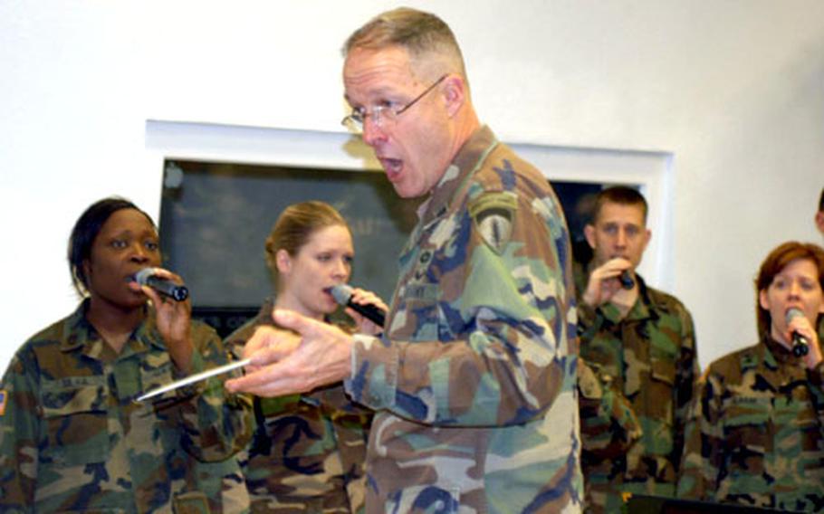 Lt. Col. Tom Palmatier, the U.S. Army Europe Band and Chorus commander, leads a rehearsal Monday at Tompkins Barracks in Schwetzingen, Germany.