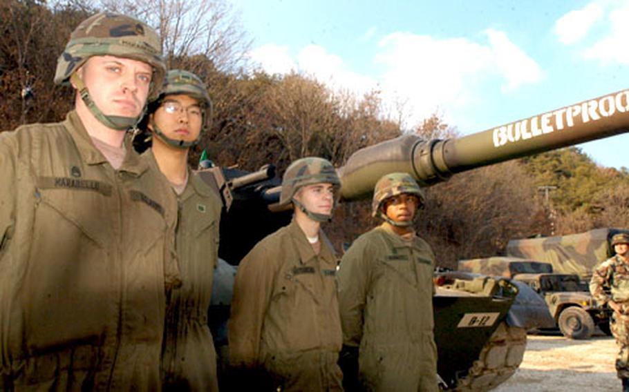 From left, Staff Sgt. Anthony Morabello, 25, of Brooklyn, N.Y., trains tankers KATUSA Cpl. Sung Jin Kyu, 21, of Puntang, South Korea; Sgt. Joshua Hutchens, 21, of Axton, Va.; and Pfc. Patrick Bennett, 23, of Killeen, Texas on skills needed to survive in Iraq.
