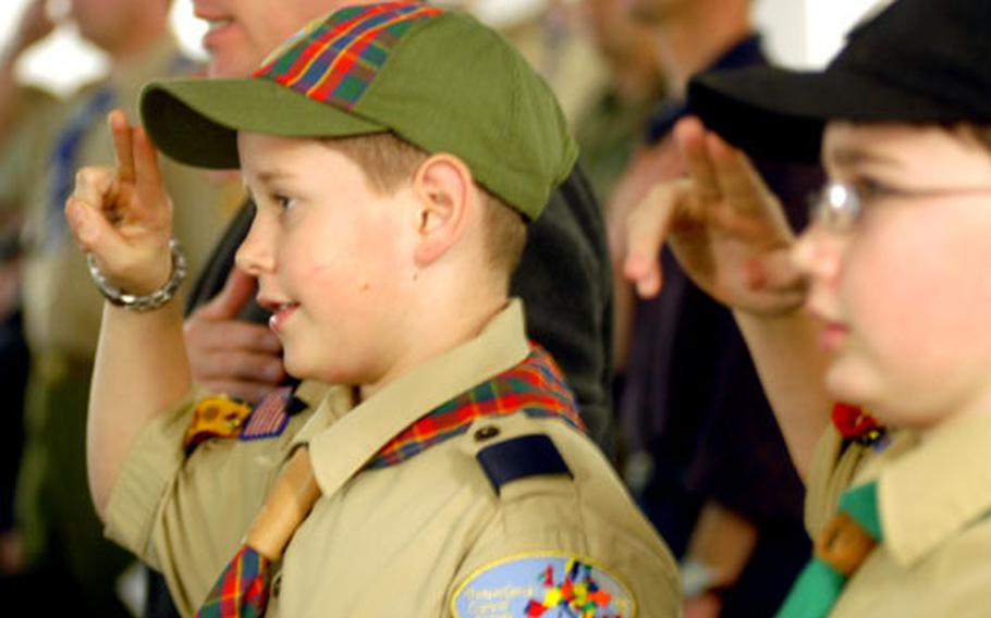 Webelos members Taylor Portman, left, and Michael Lowder stand at attention at the Boy Scouts Troop 12 Court of Honor ceremony Monday at Ramstein Air Base in Germany. Webelos, who are Cub Scouts, are required to attend several Boy Scout events before joining the group themselves.