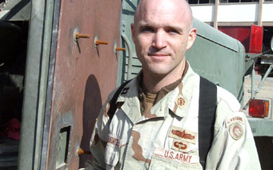 Capt. Michael DeLaughter, battalion maintenance officer for the 7th Transportation Battalion at Logistics Support Area Anaconda, Iraq, shows a homemade upgrade done to the door of a truck. Faced with driving unarmored vehicles across the dangerous Iraq roads, members of the battalion began improvising their own armor. “We took the initiative on this,” said Maj. Mark Paget, the battalion executive officer. “Nobody ever told us no.”