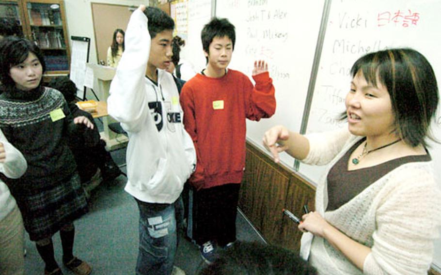 Japanese language teacher Akiko Miura works with Japanese students to choose what class they would like to attend with the students at Zama American High School. The annual event lets Japanese students experience the differences in the two school systems.