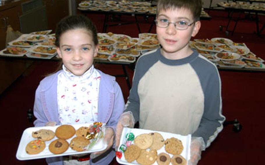 Marie Ritschard, 8, and Paul Ritschard, 11, were among 40 volunteers who helped assemble cookie packages for the annual Cookie Caper Tuesday at Misawa Air Base, Japan.