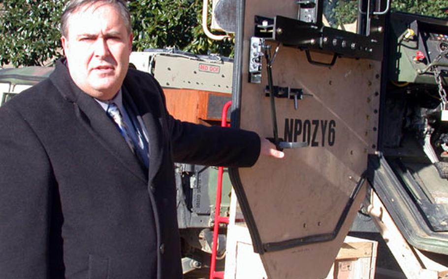 Gary Motsek, the Army’s deputy director for support operations at the U.S. Army Material Command at Fort Belvoir, Va., shows the armored plating on the door of a HEMTT, the Army’s Heavy Expanded Mobility Tactical Truck, at the Pentagon on Wednesday.