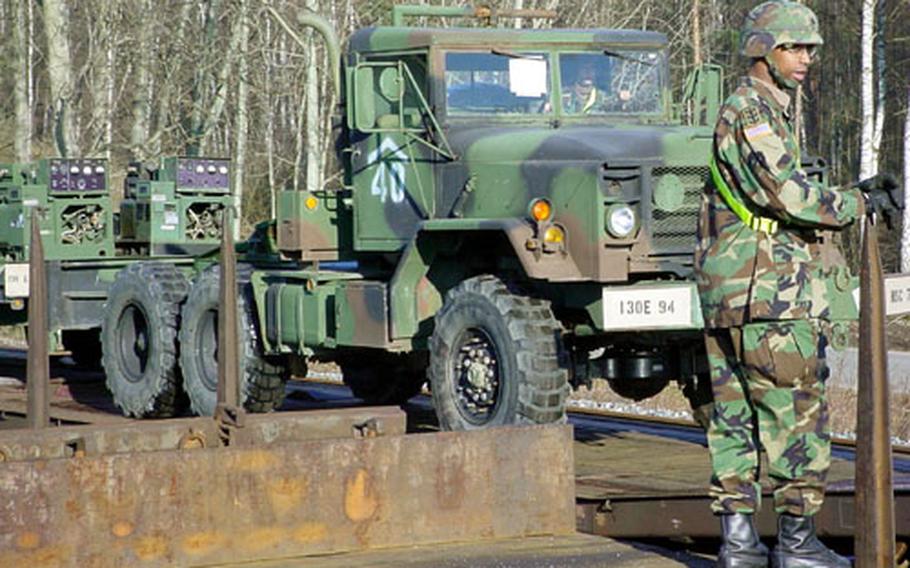 Soldiers from the 94th Engineer Battalion prepare Saturday to loaded their vehicles onto rail cars in Vilseck, Germany. More than 500 vehicles were inspected and loaded onto rail cars and long-haul tractor-trailers during the six-day operation that ended Monday.