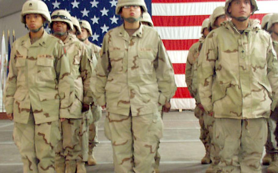 Soldiers from the 1st Infantry Division’s Division Support Command stand at attention, moments before their reunion with families at Harvey Barracks in Kitzingen, Germany. Fifty-three members of the unit returned home with the division’s advance party Saturday after serving 10 months in Iraq.