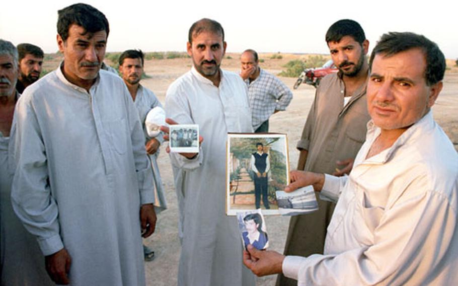 "Disappeared," was taken by Benjamin Busch in May 2003 near Badrah, a village 75 miles east of Baghdad near the Iranian border. Locals gathered to exhume a mass grave outside the town, and brought photographs of their loved ones to identify the remains by the bits of clothing left behind.