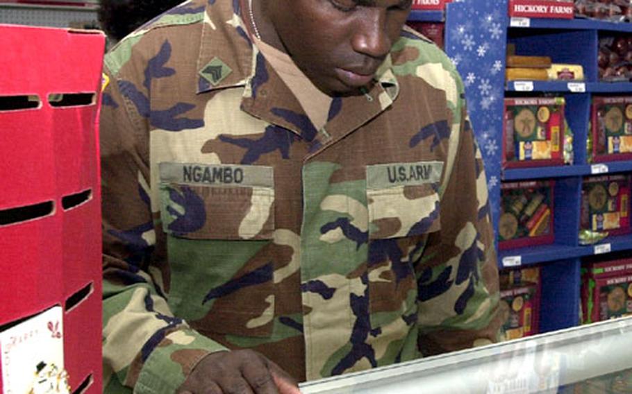 Army Sgt. Pierre Ngambo of the 58th Signal Battalion looks for jewelry as a last-minute Christmas gift for his wife Thursday morning at the Camp Foster Exchange on Okinawa. He said he always waits until the last minute to buy gifts so he can get the best deal possible.