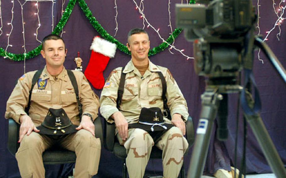 Capt. Travis Habhab, left, and his father, Chief Warrant Officer 5 Paul Habhab, reunited in Baghdad to send holiday greetings to their families in Harker Heights, Texas, live on the “Today Show.”