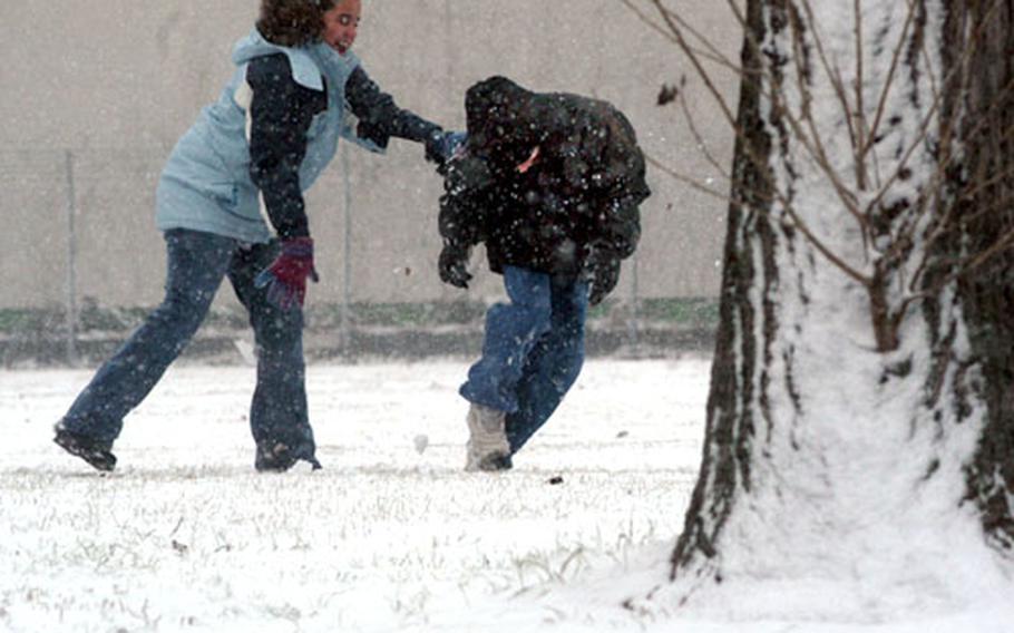 Michelle Rodrigez, 11, frolics with her brother Daniel, 13, in the freshly fallen snow near their home in Griesheim, Germany, on Tuesday.