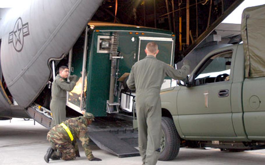 Personnel from Yokota's 36th Airlift Squadron load a mobile command post into a C-130 Tuesday afternoon. The plane was bound for Utaphao, Thailand, where crews will use a forward-operating base as a staging area for relief supplies being sent to tsunami- and earthquake-ravaged areas of Southeast Asia.